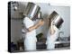 Two Chefs Having Discussion with Large Pans on their Heads-Robert Kneschke-Premier Image Canvas