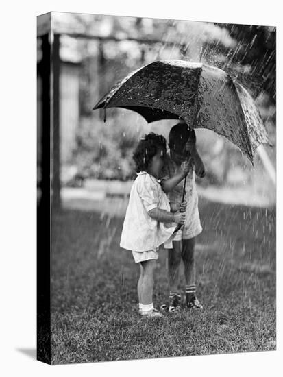 Two Children under Umbrella During a Downpour-Philip Gendreau-Premier Image Canvas