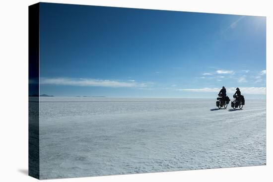 Two Cyclists Cycle in the Morning over the Salar De Uyuni-Alex Saberi-Premier Image Canvas
