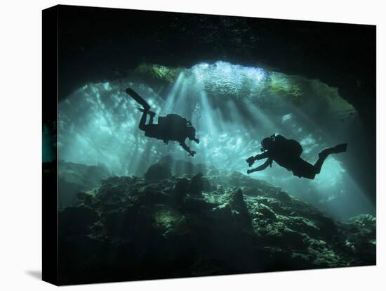 Two Divers Silhouetted in Light at Entrance to Chac Mool Cenote, Mexico-null-Premier Image Canvas