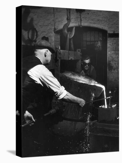 Two Factory Workers Pour Molten Metal into a Small Mould. Photograph by Heinz Zinram-Heinz Zinram-Premier Image Canvas