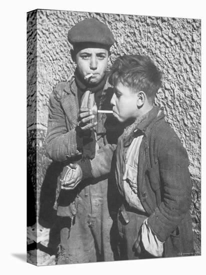 Two Homeless Boys Lighting Up American Cigarettes with British Matches-George Rodger-Premier Image Canvas