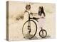 Two Little Girls by an Old Fashioned Bicycle-Nora Hernandez-Premier Image Canvas