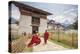 Two Monks Dressed in Traditional Red Access the Punakha Dzong, Punakha-Roberto Moiola-Premier Image Canvas