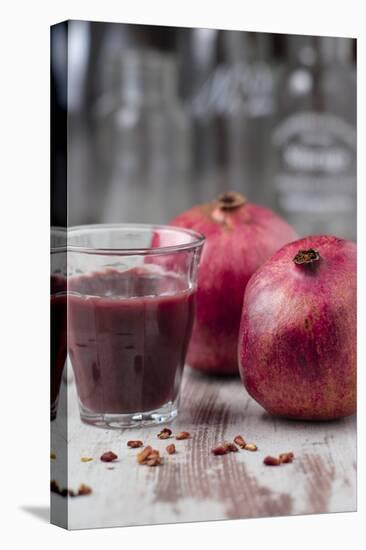 Two Pomegranates and Glass with Pomegranate Juice, Close-Up-Jana Ihle-Premier Image Canvas