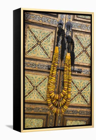 Morocco, Tinerhir. Traditional necklace of Berber woman hangs on a cabinet with camel-bone inlay-Brenda Tharp-Framed Premier Image Canvas