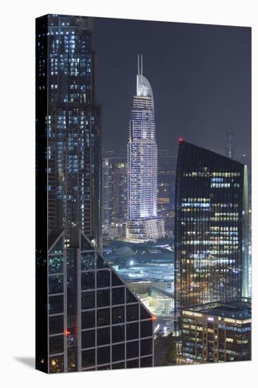 UAE, Downtown Dubai. Downtown cityscape at night lit in blue.-Walter Bibikow-Premier Image Canvas