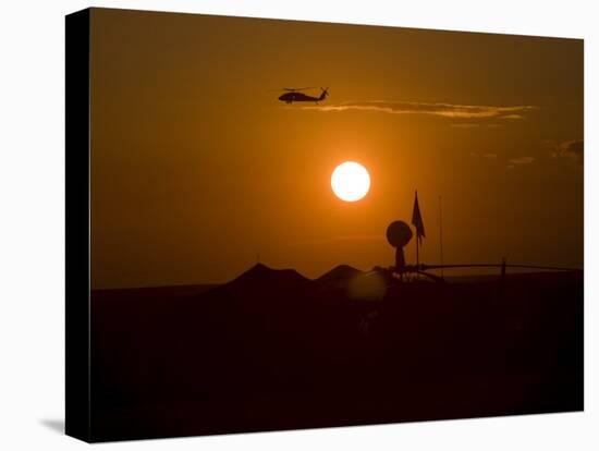 UH-60 Blackhawk Flies over Camp Speicher Airfield at Sunset-Stocktrek Images-Premier Image Canvas