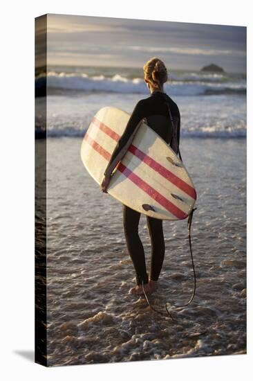 Uk, Cornwall, Polzeath. a Woman Looks Out to See, Preparing for an Evening Surf. Mr-Niels Van Gijn-Premier Image Canvas