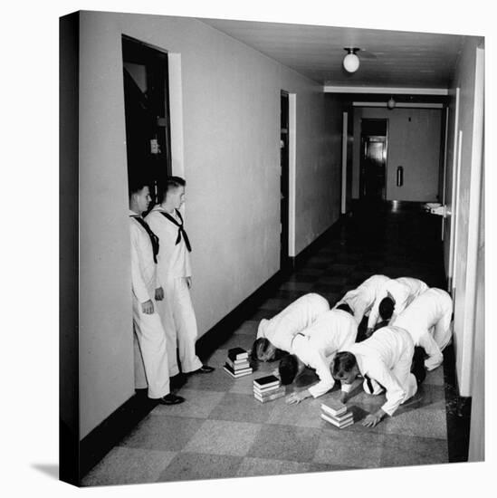 US Coast Guard Academy, Lower Classmen Bowing over Books, Hoping for Luck in Examinations-William C^ Shrout-Premier Image Canvas