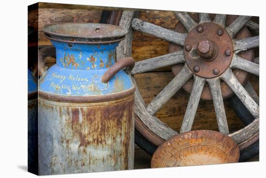 USA, Alaska. Antique milk can, wagon wheel and gold pan.-Jaynes Gallery-Premier Image Canvas
