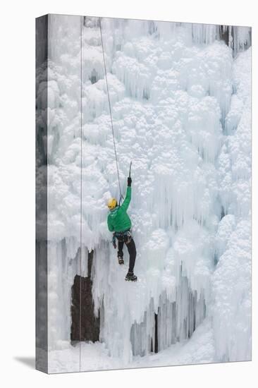 USA, Colorado, Uncompahgre National Forest. Climber ascends ice-encrusted cliff face.-Jaynes Gallery-Premier Image Canvas