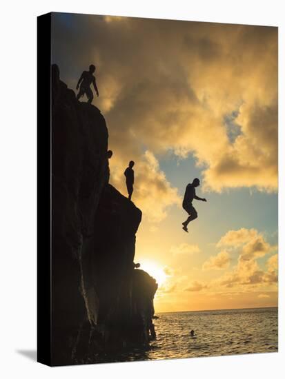 USA, Hawaii, Oahu,  North Shore, Waimea Bay, Divers Jumping Off Cliff-Michele Falzone-Premier Image Canvas