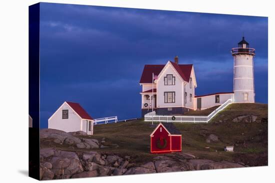 USA, Maine, York Beach, Nubble Light Lighthouse with Christmas decorations at dusk-Walter Bibikow-Premier Image Canvas