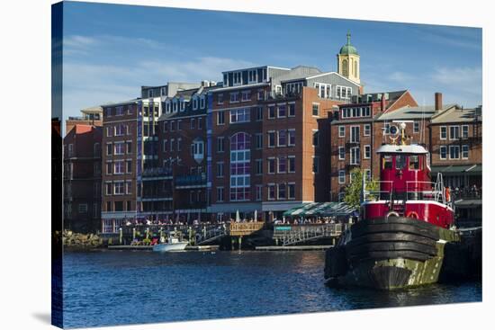 USA, New Hampshire, Portsmouth, waterfront buildings with tugboat-Walter Bibikow-Premier Image Canvas