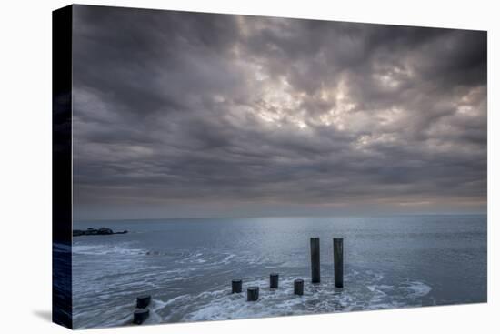 USA, New Jersey, Cape May National Seashore. Beach pilings on stormy sunrise.-Jaynes Gallery-Premier Image Canvas