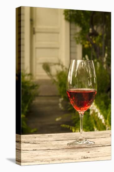 USA, Washington, Prosser. A glass of red wine on a picnic table outside of eastern Washington-Richard Duval-Premier Image Canvas