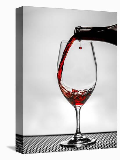 USA, Washington, Spokane. Red wine poured into wine glass creates perfect round drop,-Richard Duval-Premier Image Canvas
