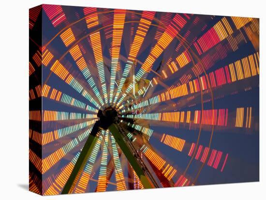 USA, Washington State, Puyallup, ferris wheel in motion at annual Puyallup Fair at night.-Merrill Images-Premier Image Canvas