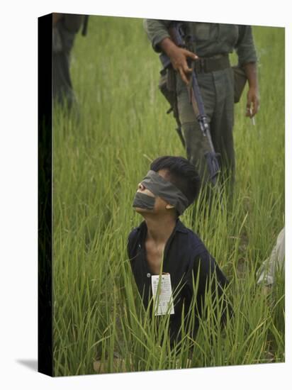 Viet Cong Prisoner Being Guarded by Marines, Mouth and Eyes Taped to Prevent From Calling for Help-Paul Schutzer-Premier Image Canvas