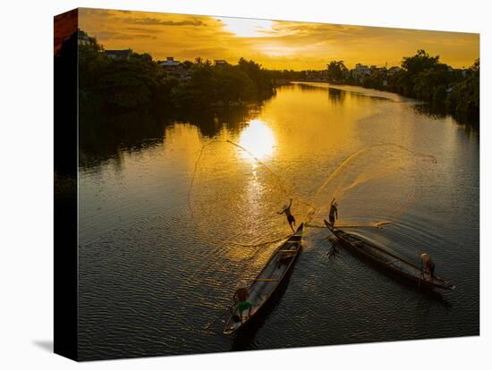 Vietnam. Coordinated lagoon fishing with nets at sunset.-Tom Norring-Premier Image Canvas