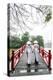 Vietnam, Hanoi, Hoan Kiem Lake. Walking on Huc Bridge in Traditional Ao Dai Dress-Matteo Colombo-Premier Image Canvas