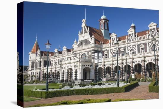 View from gardens to the imposing facade of Dunedin Railway Station, Anzac Square, Dunedin, Otago, -Ruth Tomlinson-Premier Image Canvas
