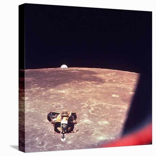 View of Apollo 16 Moon Lander Flying over Moon Landscape with Earth Appearing over the Horizon-null-Premier Image Canvas