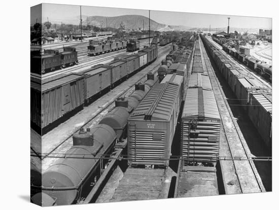 View of Freight Trains, Boxcars and Tank Cars, Standing on Tracks in Small Railroad Yard-null-Premier Image Canvas