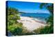 View of Spiaggia Cala d'Ambra beach and Isola di Tavolara in background, San Teodoro, Sardinia-Frank Fell-Premier Image Canvas