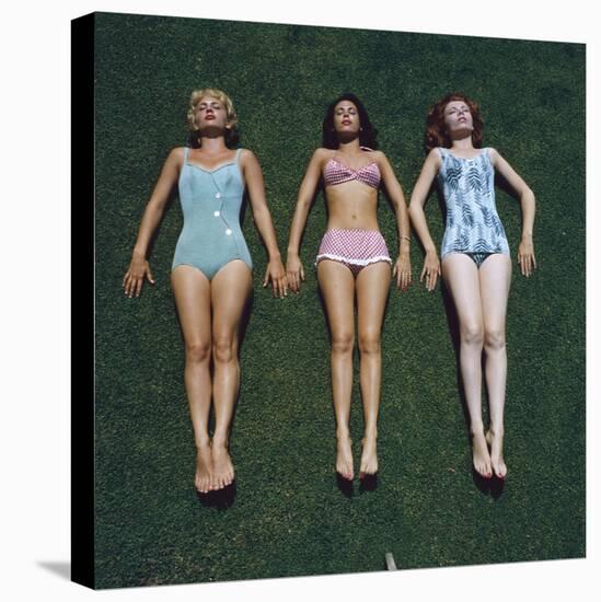 View of Three Unidentified Women in Bathing Suits as They Sunbath on Green Grass, 1961-Allan Grant-Premier Image Canvas
