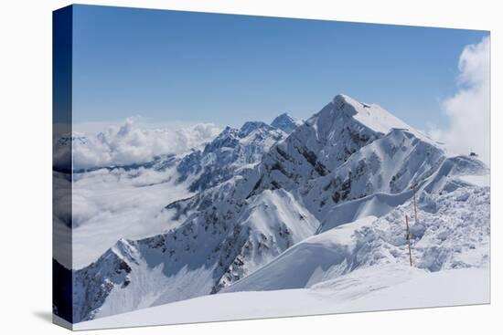 View on Winter Snowy Mountains and Blue Sky above Clouds, Krasnaya Polyana, Sochi, Russia-wasja-Premier Image Canvas