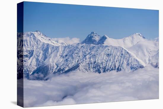 View on Winter Snowy Mountains and Blue Sky above Clouds, Krasnaya Polyana, Sochi, Russia-wasja-Premier Image Canvas