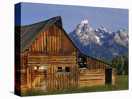 Weathered Wooden Barn Along Mormon Row with the Grand Tetons in Distance, Grand Teton National Park-Dennis Flaherty-Premier Image Canvas