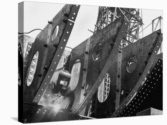 Welder Securing Steel Structure While Working on Hull of a Ship, Bethlehem Shipbuilding Drydock-Margaret Bourke-White-Premier Image Canvas