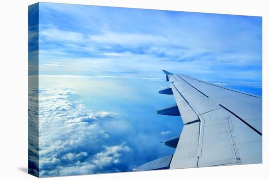 Wing of an Airplane Flying Above the Clouds-ghoststone-Premier Image Canvas