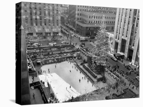 With the Famed Rockefeller Center Christmas Tree Rising Above Them, Skaters Glide on the Ice-null-Premier Image Canvas