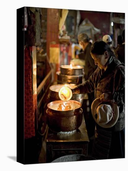Woman Adding the Melting Yak Butter from Her Lamp to Those of the Temple, Bharkor, Tibet-Don Smith-Premier Image Canvas
