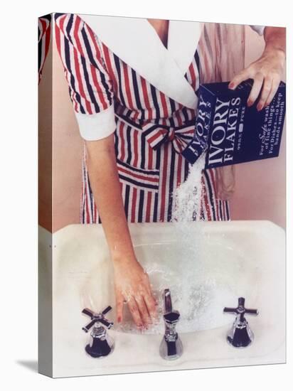 Woman in Red, White and Blue Robe Pouring Ivory Soap Flakes Into Bathroom Sink-Gjon Mili-Premier Image Canvas