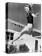 Woman Leaping over a Tennis Net-null-Stretched Canvas