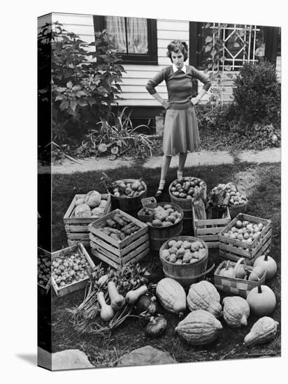 Woman Looking at Victory Garden Harvest Sitting on Lawn, Waiting to Be Stored Away for Winter-Walter Sanders-Premier Image Canvas