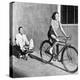 Woman on a Bicycle Pulling a Grown Man on a Toy Tricycle-null-Stretched Canvas
