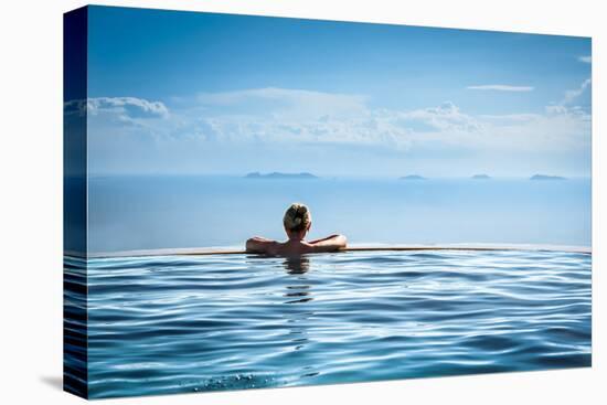 Woman Relaxing in Infinity Swimming Pool on Vacation-Splendens-Premier Image Canvas