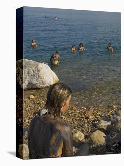 Woman's Back Covered with Mud and People Floating in the Sea in Background, Dead Sea, Israel-Eitan Simanor-Premier Image Canvas