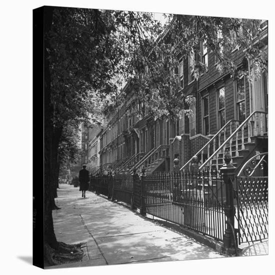 Woman Walking Down Street in Front of Apartment Buildings-Ed Clark-Premier Image Canvas