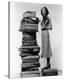 Woman With Pile Of Large Books-null-Stretched Canvas