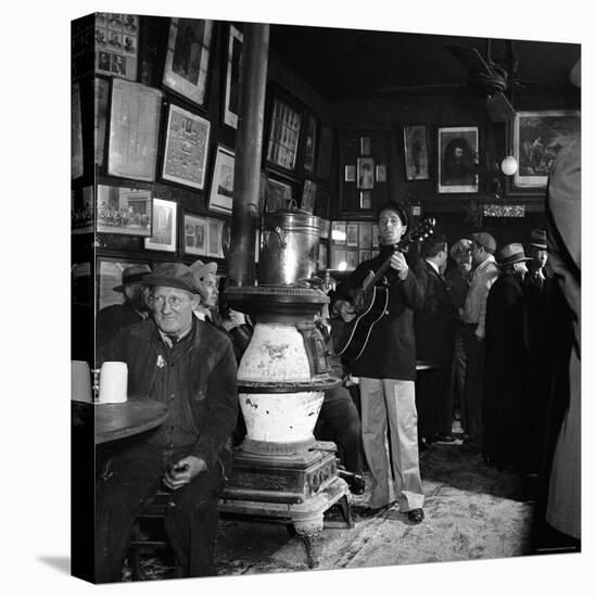 Woody Guthrie Playing in McSorley's Pub-Eric Schaal-Premier Image Canvas