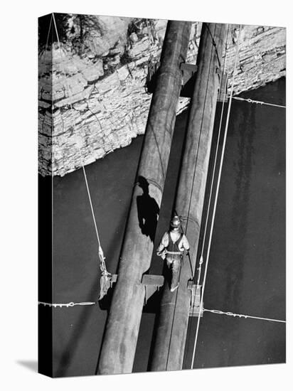 Worker Walking on the Texas Illinois Natural Gas Company's Pipeline Suspension Bridge-John Dominis-Premier Image Canvas