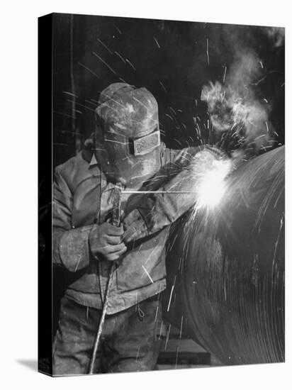 Worker Welding Pipe Used in Natural Gas Pipeline at World's Biggest Coal Fueled Generating Plant-Margaret Bourke-White-Premier Image Canvas