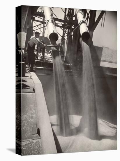Workers Guiding Granary Filling Spouts as They Pour Tons of Wheat into River Barge for Shipment-Margaret Bourke-White-Premier Image Canvas